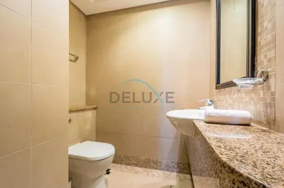 a bathroom with a toilet and a sink at Elegant 2BR in Sky Gardens DIFC by Deluxe Holiday Homes in Dubai