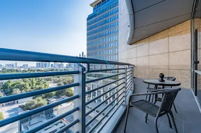 a balcony with a table and chair on a building at Elegant 2BR in Sky Gardens DIFC by Deluxe Holiday Homes in Dubai