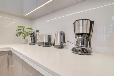a kitchen counter with three appliances on it at Forte 2, Downtown Dubai - Mint Stay in Dubai