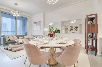 a living room with a white table and chairs at Forte 2, Downtown Dubai - Mint Stay in Dubai