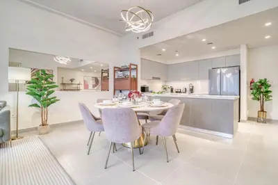 a kitchen and dining room with a table and chairs at Forte 2, Downtown Dubai - Mint Stay in Dubai