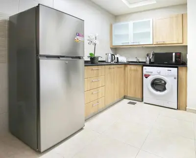 a kitchen with a refrigerator and a washing machine at Studio in Dubai Marina by beach & Metro - Z313 in Dubai