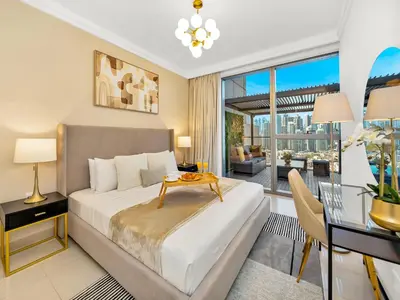 a bedroom with a bed and a desk and a table at Kensington Stylish 1BR at The Lofts East Downtown in Dubai