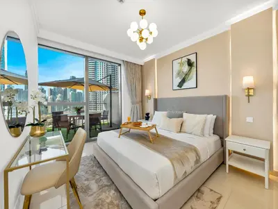 a bedroom with a large bed and a balcony at Kensington Stylish 1BR at The Lofts East Downtown in Dubai