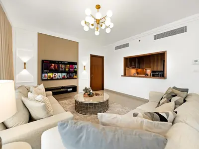 a living room with two couches and a tv at Kensington Stylish 1BR at The Lofts East Downtown in Dubai