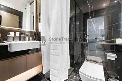 a bathroom with a shower and a toilet and a sink at High-Floor and Spacious 1BR at Binghatti Emerald in Dubai