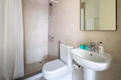 a bathroom with a white toilet and a sink at Frank Porter - Ranches 3 in Dubai