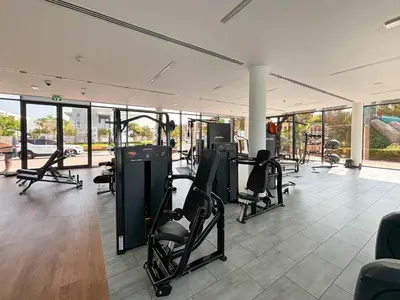 a gym with treadmills and chairs in a room at Frank Porter - Ranches 3 in Dubai