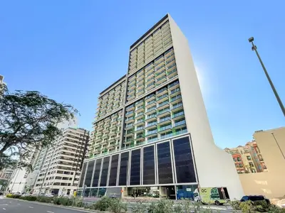 a tall building with many windows in a city at Modern and High Floor 1BR at Binghatti Emerald in Dubai