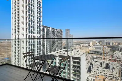 a table and two chairs on the balcony of a building at Modern and High Floor 1BR at Binghatti Emerald in Dubai