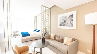 a living room with a couch and a bed at Conveniently Located Apartment With Waterfront View in Dubai