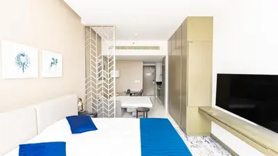 a hotel room with a bed and a television at Conveniently Located Apartment With Waterfront View in Dubai