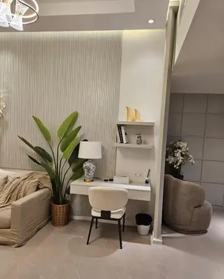 a living room with a desk and a chair at Marina View Tower A in Dubai
