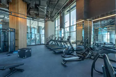 a gym with rows of treadmills and exercise bikes at Luxury Apartment with Burj Khalifa View, Balcony Netflix WeHome Premium in Dubai