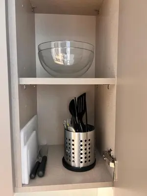 a shelf with a bowl and utensils in it at Gennaro's Home at 15 Northside Business Bay in Dubai