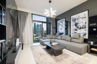 a living room with a couch and a large window at Luxury 4BR Burj Khalifa View Dubai Mall in Dubai