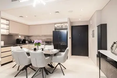 a kitchen with a dining room table and chairs at Luxury 4BR Burj Khalifa View Dubai Mall in Dubai