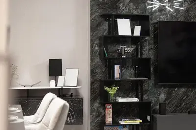 a living room with a clock on the wall at Luxury 4BR Burj Khalifa View Dubai Mall in Dubai