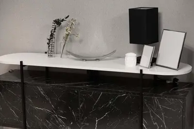 a white table with a vase of flowers on it at Luxury 4BR Burj Khalifa View Dubai Mall in Dubai