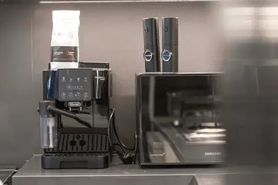 a counter with a coffee maker and a microwave at Luxury 4BR Burj Khalifa View Dubai Mall in Dubai
