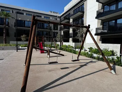 an empty playground in front of a building at Oakley Square Oasis in JVC in Dubai