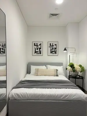 a white bedroom with a large bed in it at Oakley Square Oasis in JVC in Dubai