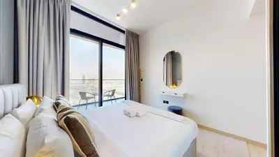 a hotel room with a bed and a large window at Locations I Binghatti Luna - JVC I Modern 1BR Apartment I Upgraded Interiors & Comfortable Stay I Scenic Community & Skyline Views in Dubai