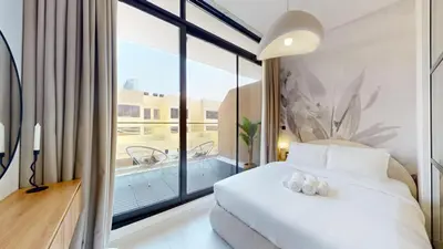a hotel room with a bed and a large window at Loci Residences - Vibrant Studio in JVC in Dubai