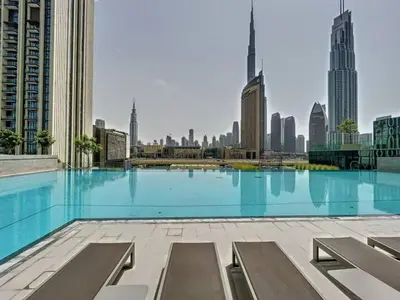 a large swimming pool with a city skyline in the background at Vacationer l High Rise 1 Bedroom l Close to Dubai Mall l Pool Access with Burj Khalifa Views in Dubai