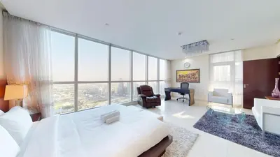 a large bedroom with a large bed and a desk at Vacationer I Lux 3 Bedroom Apartment I Steps from Barasti Beach in Dubai