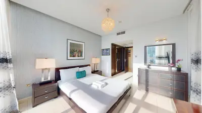 a bedroom with a large white bed and a window at Vacationer I Lux 3 Bedroom Apartment I Steps from Barasti Beach in Dubai