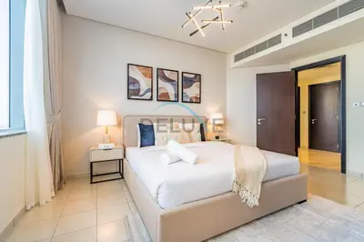 a bedroom with a large white bed in a room at Delightful 2BR at Sky Gardens DIFC by Deluxe Holiday Homes in Dubai