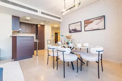 a kitchen and dining room with a table and chairs at Delightful 2BR at Sky Gardens DIFC by Deluxe Holiday Homes in Dubai