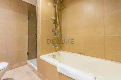 a bathroom with a bath tub and a toilet at Delightful 2BR at Sky Gardens DIFC by Deluxe Holiday Homes in Dubai