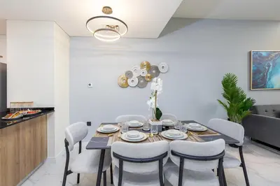 a dining room with a table and chairs at Family Friendly, 2BR Townhouse in Rukan Community, Dubai Land - Allsopp & Allsopp in Dubai