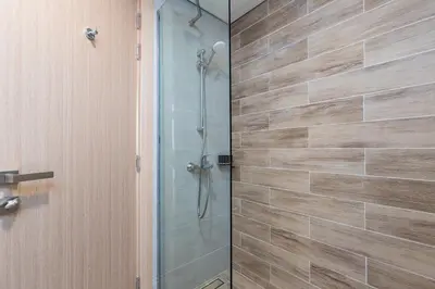 a shower in a bathroom with a glass door at Family Friendly, 2BR Townhouse in Rukan Community, Dubai Land - Allsopp & Allsopp in Dubai