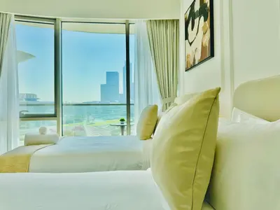 a hotel room with two beds and a large window at Venduras Homes -Grande Tower, Downtown Dubai, Burj Khalifa & Fountain Views in Dubai