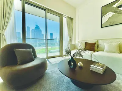 a living room with a couch and a chair and a table at Venduras Homes -Grande Tower, Downtown Dubai, Burj Khalifa & Fountain Views in Dubai