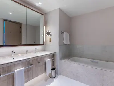 a bathroom with a tub and a sink and a mirror at Beach Rental- Grand Creek Harbour in Dubai in Dubai