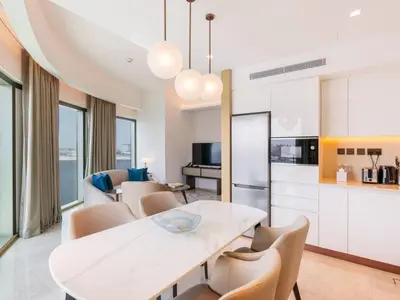 a kitchen and dining room with a white table and chairs at Beach Rental- Grand Creek Harbour in Dubai in Dubai
