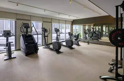 a gym with several treadmills and elliptical machines at Beach Rental- Grand Creek Harbour in Dubai in Dubai