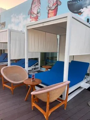 a deck on a cruise ship with chairs and tables at Suite in Seven Palm Corner Unit Rooftop Floor in Dubai
