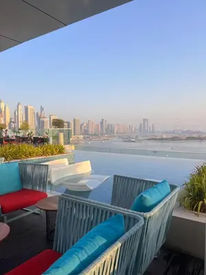 a balcony with chairs and a view of the city at Suite in Seven Palm Corner Unit Rooftop Floor in Dubai