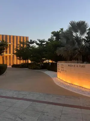 a sign in front of a building with trees at Suite in Seven Palm Corner Unit Rooftop Floor in Dubai