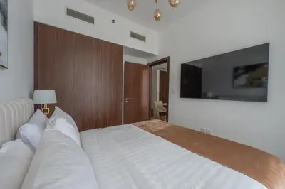 a bedroom with a bed and a tv on the wall at Wohnung mit Blick auf den Burj Khalifa im Stadtzentrum von Dubai in Dubai