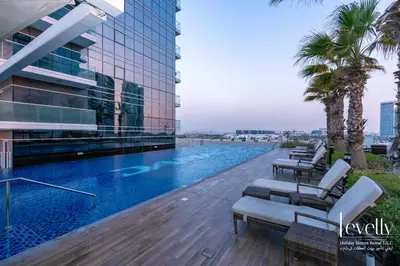 a swimming pool on the roof of a building at Luxury Studio in DAMAC Hills with Premium Amenities in Dubai