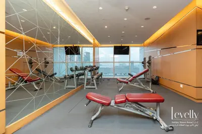 a gym with cardio equipment in a building at Luxury Studio in DAMAC Hills with Premium Amenities in Dubai