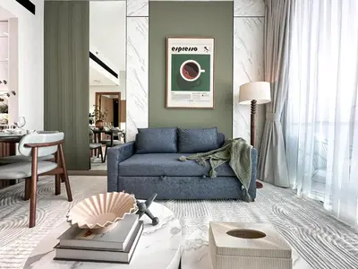 a living room with a blue couch and a table at Trophy Luxury Stellar Sky Suites in JVC with Great Views in Dubai