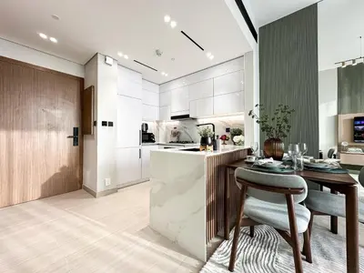 a kitchen and dining room with a table and a counter at Trophy Luxury Stellar Sky Suites in JVC with Great Views in Dubai