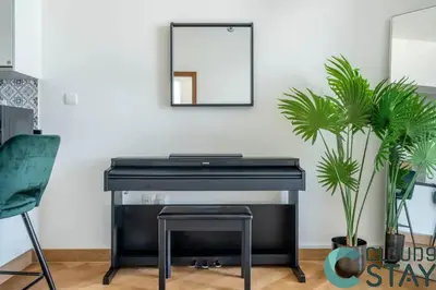 a black piano in a room with a mirror at Cloud 9 - Luxurious 1 Bedroom Apartment in Business Bay in Dubai